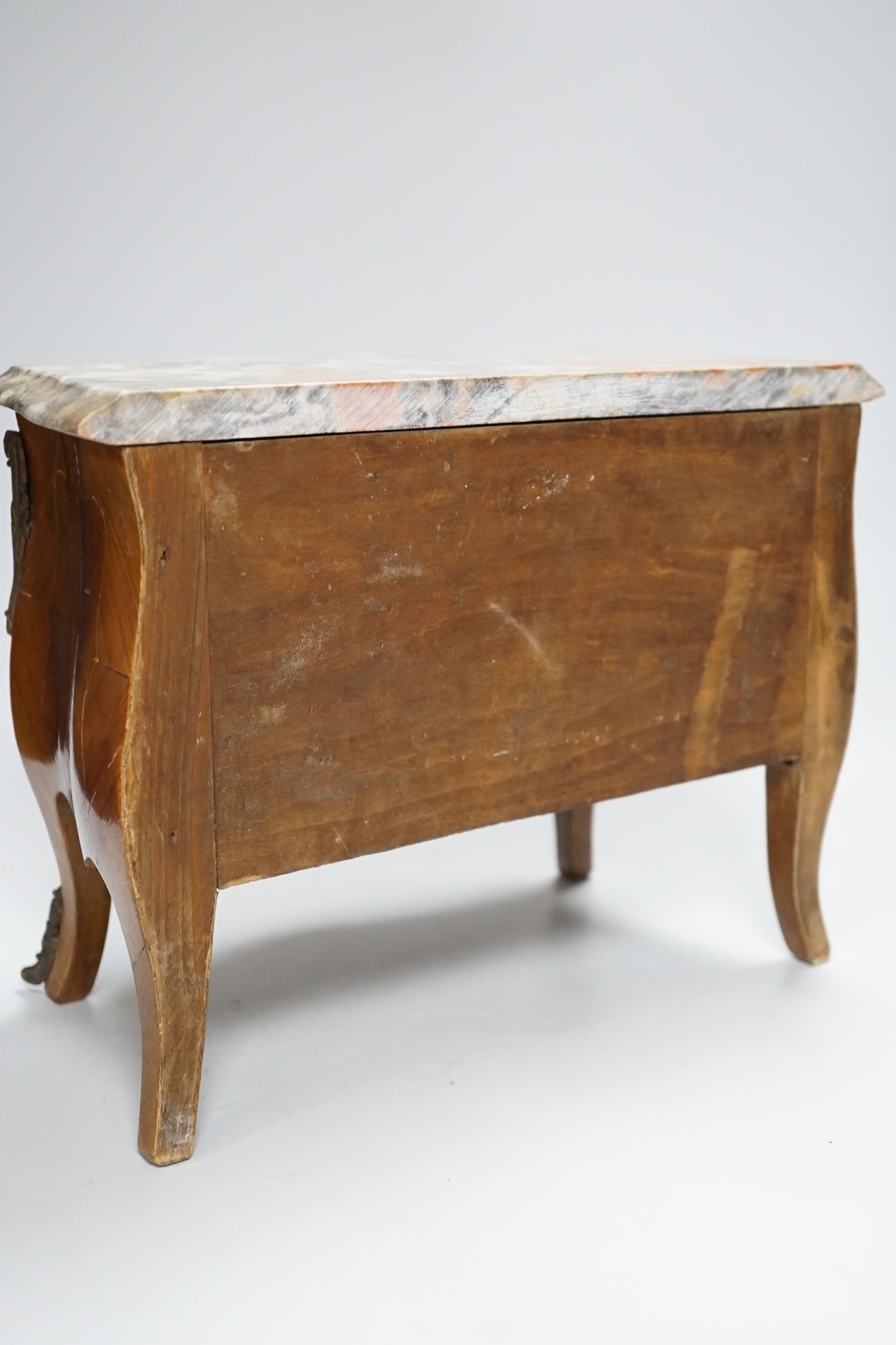 An Apprentice piece: Louis XV style miniature bowfronted French chest, with gilt mounts and pink and grey marble top. 27cm tall, 36cm wide, 17cm deep